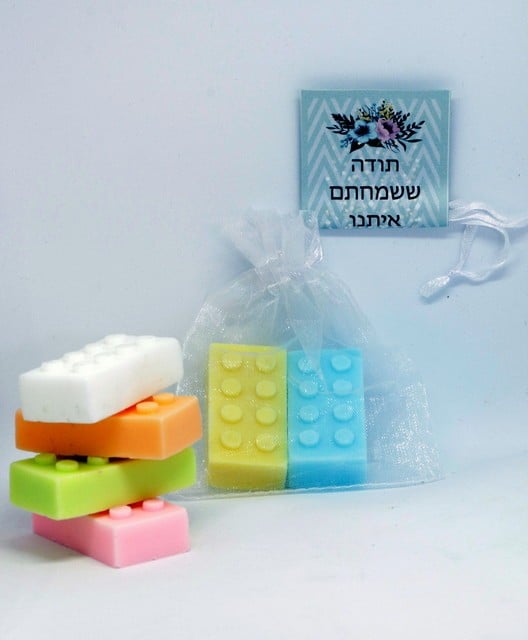 A pair of LEGO soaps with a personalized branding sticker