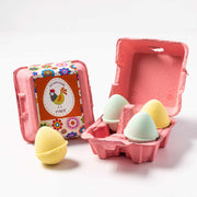 An egg carton with happy bath bombs